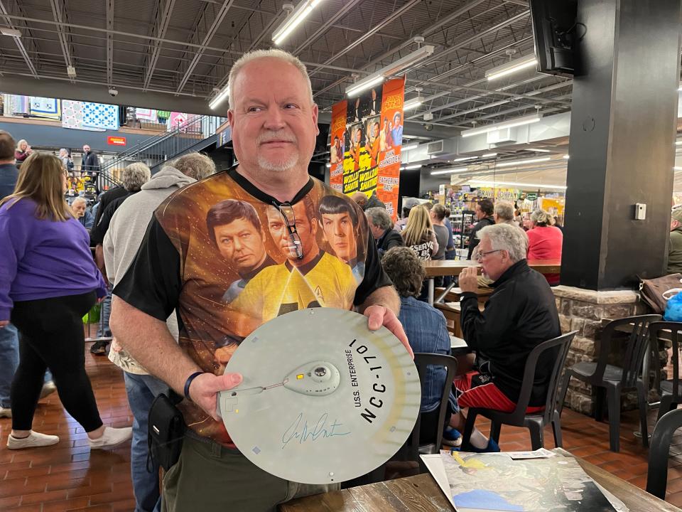 Matt Merew, 56, of Zanesville shows his model of the saucer section of the starship Enterprise that he got Star Trek star William Shatner to autograph Saturday at Hartville MarketPlace.