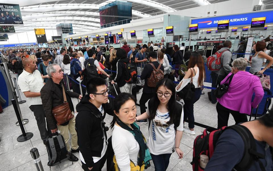 British Airways passengers wait at Heathrow Airport in May 2017