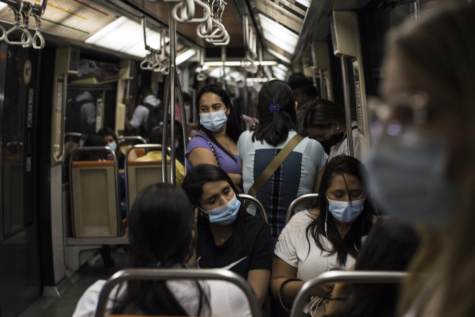 People wearing face masks take the train during lockdown in Santiago, Chile on December 12. Source: Getty