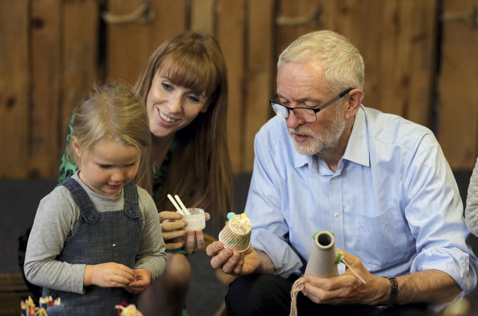 Labour leader Jeremy Corbyn and Shadow Education Secretary Angela Rayner during a visit to the Scrap Creative Reuse Arts Project while on the General Election campaign trail in Leeds, England, Saturday, Nov. 9, 2019. British political leaders are swapping blame over floods that have drenched parts of England as the deluge becomes an issue in the campaign for the Dec. 12 election. (Nigel Roddis/PA via AP)