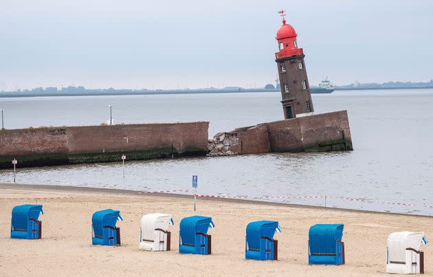 Beach chairs stay on the beach next to the leaning Mole tower in Bremerhaven, Germany, Thursday, Aug. 18, 2022. Officials in Bremen said Thursday that an iconic lighthouse at the German city’s port has tilted sideways and could soon topple over entirely. (Sina Schuldt/dpa via AP) (Photo: via Associated Press)