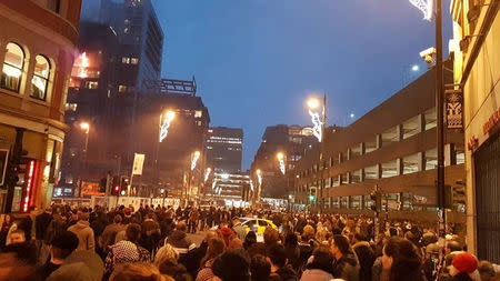 People watch as fire breaks out at an apartment block in Manchester, Britain December 30, 2017 in this image obtained from social media. TWITTER/@MANCTRAFFIC/via REUTERS.