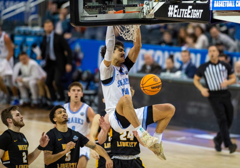 Nova Southeastern’s RJ Sunahara (13) dunks the ball as the Nova Southeastern University Sharks play the West Liberty Hilltoppers during the championship game of the 2023 NCAA Division II Men’s basketball tournament at Ford Center in Downtown Evansville, Ind., Saturday afternoon, March 25, 2023.