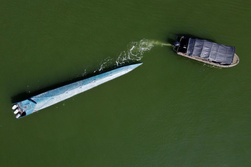 TOPSHOT - Aerial view of a seized narco-submarine towed by a Colombian Navy ship in Buenaventura, Valle del Cauca department, Colombia, on March 21, 2021. - The submarine, which contained several packages of cocaine and was destined for the coasts of Mexico, belonged to a dissident armed group of the FARC guerrilla, according to authorities. (Photo by Luis ROBAYO / AFP) (Photo by LUIS ROBAYO/AFP via Getty Images)