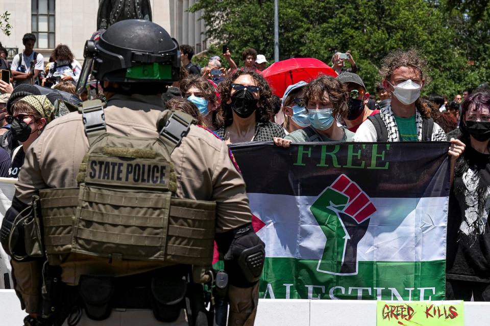 Pro-Palestinian protesters stand with linked arms surrounded by Texas state troopers and police at an encampment at the University of Texas, Austin on 29 April. Officials have made dozens of arrests at the school in recent days (Austin American-Statesman)