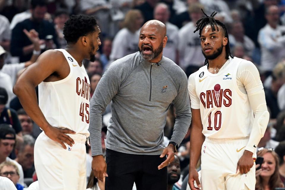 Cleveland Cavaliers coach J.B. Bickerstaff, center, talks with Donovan Mitchell (45) and Darius Garland (10) during the first half of Game 1 in a first-round NBA basketball playoffs series against the New York Knicks, Saturday, April 15, 2023, in Cleveland.