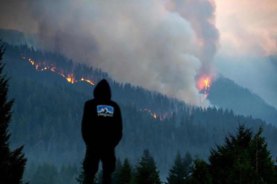 Firefighter Cole Campbell from Prineville prepares for another day on the fireline as the Lookout Fire burns above his campsite at Tokatee Golf Course in McKenzie Bridge east of Springfield in August.