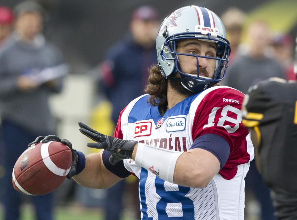 Jonathan Crompton, seen against Hamilton last Nov. 23, has donated his long hair to Locks of Love. (Fred Thornhill/Reuters.)