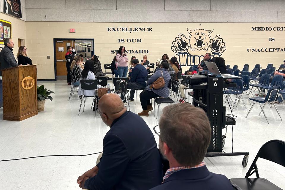 Jacky Johnson (center with microphone) shares parent feedback at a SCCPSS Town Hall meeting on Dec. 12, 2023 at West Chatham Middle School. SCCPSS Board President, Roger Moss (front, left) and District 7 Representative, Michael Johnson (front, right) listen.