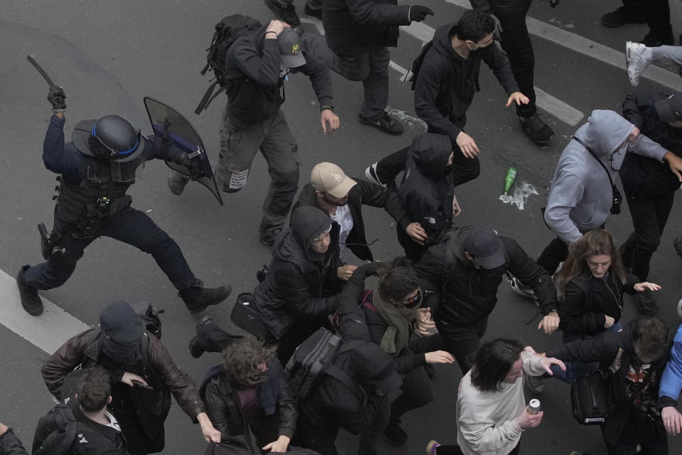 Riot police scuffle with protesters during a rally in Paris, France, March 23, 2023. / Credit: Christophe Ena/AP