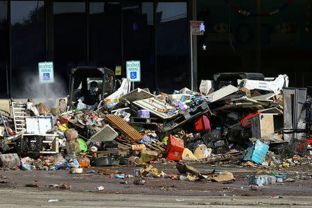 Machines are used to clean out a grocery store as the clean-up continues at a neighborhood shopping plaza following the aftermath of tropical storm Harvey in Houston, Texas, U.S., September 9, 2017. REUTERS/Mike Blake