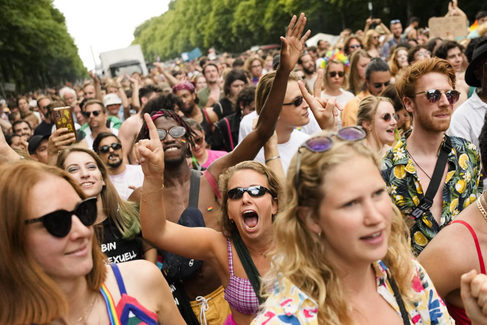 Revelers dance as they take part in the annual pride march in Berlin, Germany, Saturday, July 23, 2022. Draped in rainbow flags, around 150,000 people were marching for LGBTQ rights at Berlin's annual Christopher Street Day celebration. Berlin police gave the crowd estimate on Saturday afternoon but said the number could grow into the evening. (AP Photo/Markus Schreiber)