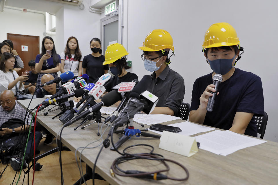 Protesters from right, Jerry Chan, Linus Kim and Mary Tsang attend a press conference in Hong Kong, Tuesday, Aug. 6, 2019. They condemned what they call the government's "empty rhetoric" and instances of alleged police abuse in an inaugural "People's Press Conference." (AP Photo/Kin Cheung)