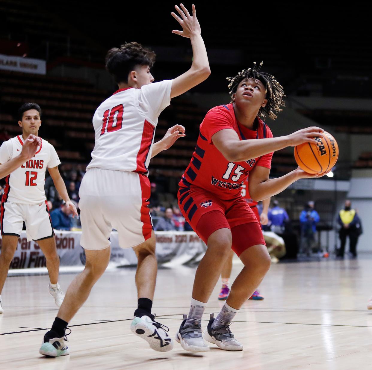 Tulare Western's Jaydon Henningham drives against Kerman during their Central Section Division IV Boys Championship game at Selling Arena in Fresno, Calif., Friday, Feb. 24, 2023.