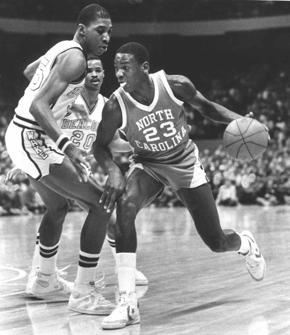 The file photo from Feb. 17, 1982 shows North Carolina's Michael Jordan driving around the defense of Wake Forest's Anthony Teachey, left, and Danny Young (20) at the Greensboro Coliseum in Greensboro, N.C.