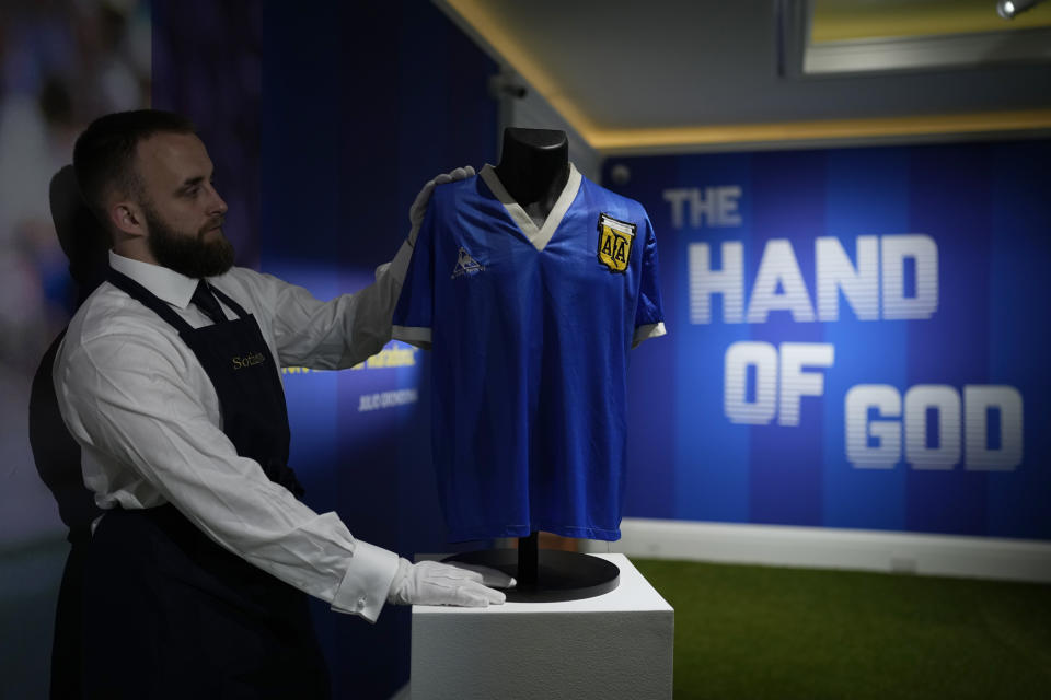 FILE - The Argentina football shirt worn by Diego Maradona in the 1986 Mexico World Cup quarterfinal soccer match between Argentina and England, is displayed for photographs at Sotheby's auction house, in London, Wednesday, April 20, 2022. The shirt worn by Maradona when he scored the controversial “Hand of God” goal has sold for 7.1 million pounds ($9.3 million), the highest price ever paid at auction for a piece of sports memorabilia. Auctioneer Sotheby’s sold the shirt in an online auction that closed Wednesday, May 4, 2022. (AP Photo/Matt Dunham, File)