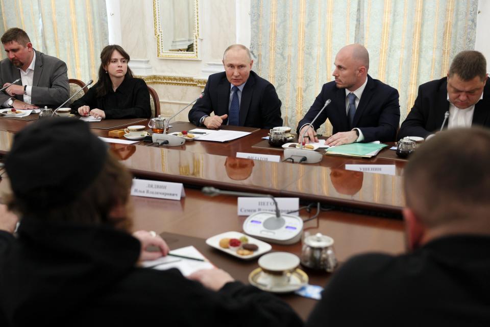 Russian President Vladimir Putin, center, speaks during a meeting with Russian war correspondents who cover a special military operation, at the Kremlin in Moscow, Russia, Tuesday, June 13, 2023. (Gavriil Grigorov, Sputnik, Kremlin Pool Photo via AP)