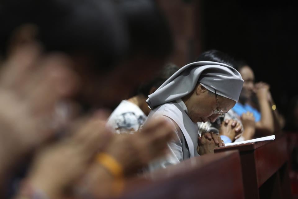 In this Friday, Oct. 18, 2019, photo, Catholic devotees and nuns pray at the Christ Church during the 30th anniversary of the beatification of seven martyrs in Songkhon village, Mukdahan province, northeastern of Thailand. In 1940, seven villagers here were executed for refusing to abandon their Catholic faith, which Thai nationalists had equated with loyalty to France, whose colonial army in neighboring Indochina had fought Thailand in a brief border war. The seven were beatified in 1989 by Pope John Paul II, the first step to being named a saint. (AP Photo/Sakchai Lalit)