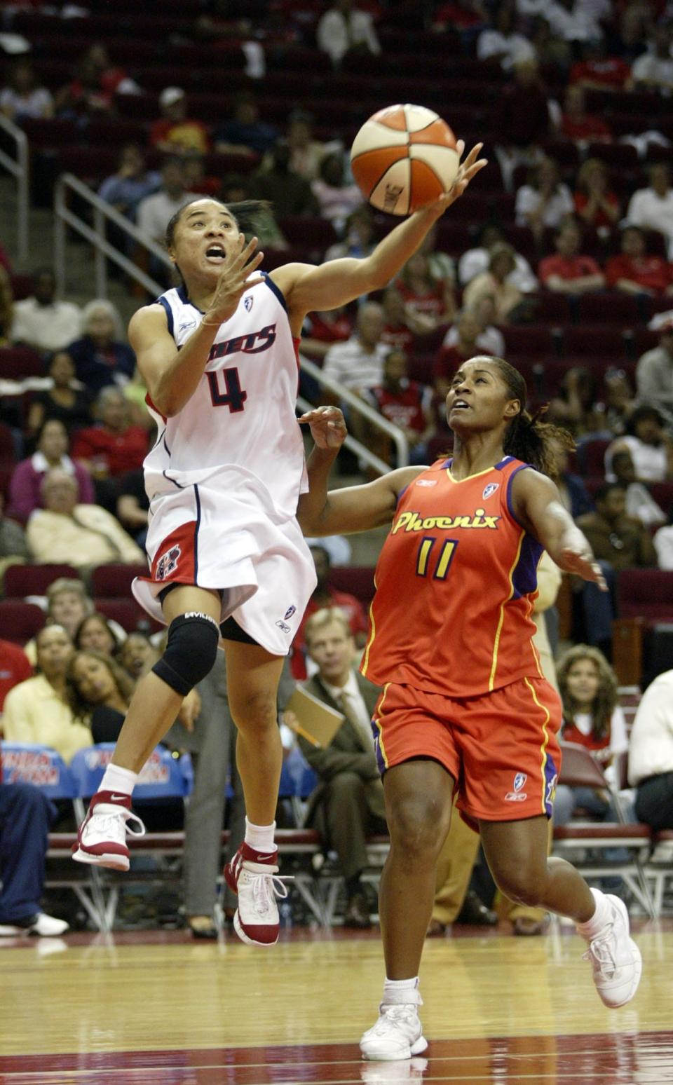 Houston Comets' Dawn Staley (4) drives the ball to the basket against Phoenix Mercury's Niele Ivey (11) Aug. 18, 2005, in Houston. The Comets won, 77-66. 