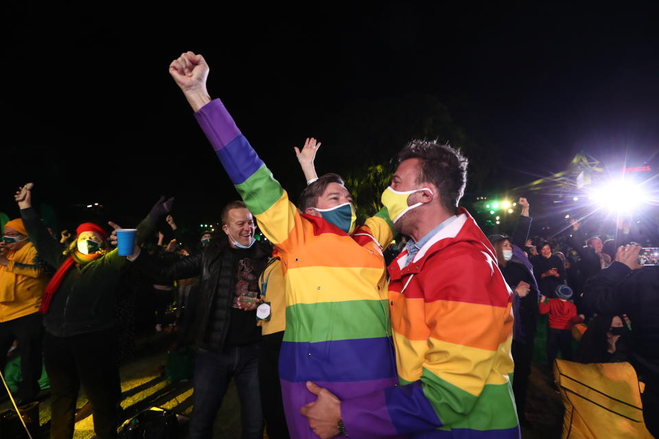 People celebrate in Brisbane, Australia, Wednesday, July 21, 2021, following an announcement by the International Olympic Committee that Brisbane was picked to host the 2032 Olympics. The Australian city was the inevitable winner of a one-candidate race steered by the IOC to avoid rival bids. (Jason O'Brien/AAP Image via AP)