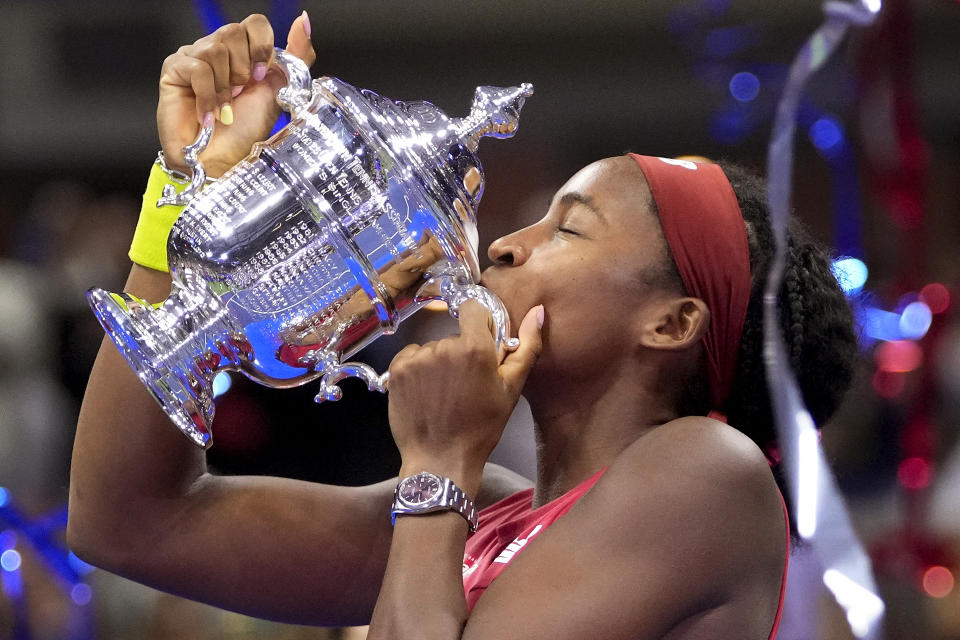 Coco Gauff, of the United States, kisses the championship trophy after defeating Aryna Sabalenka, of Belarus, in the women's singles final of the U.S. Open tennis championships, Saturday, Sept. 9, 2023, in New York. (AP Photo/Frank Franklin II)