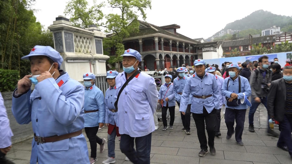 Tourists from the southern Henan province wear Red Army uniforms as they walk towards the Zunyi Memorial Museum in the city of Zunyi in Southwestern China's Guizhou province on April 12, 2021. The museum, located at the site of the Zunyi Conference, was where the late Communist leader Mao Zedong rose to power. (AP Photo/Emily Wang)