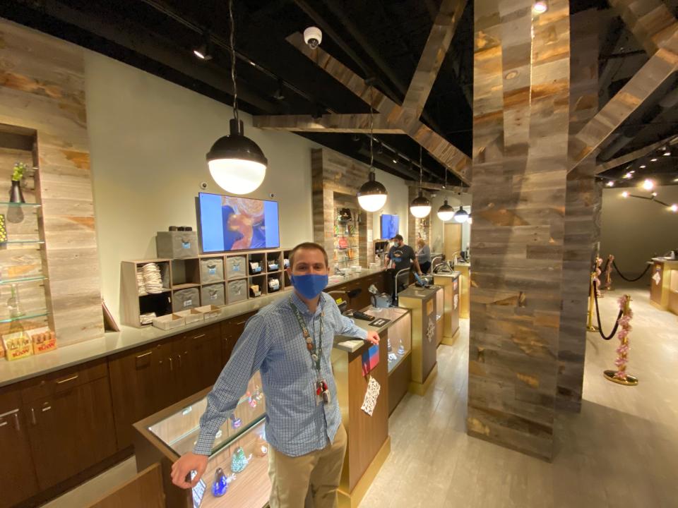 Derek LoVasco, retail manager for Commonwealth Alternative Care on Mozzone Boulevard in Taunton, pauses for a photo on Monday, Dec. 20, 2021, the dispensary's first day for retail sales.