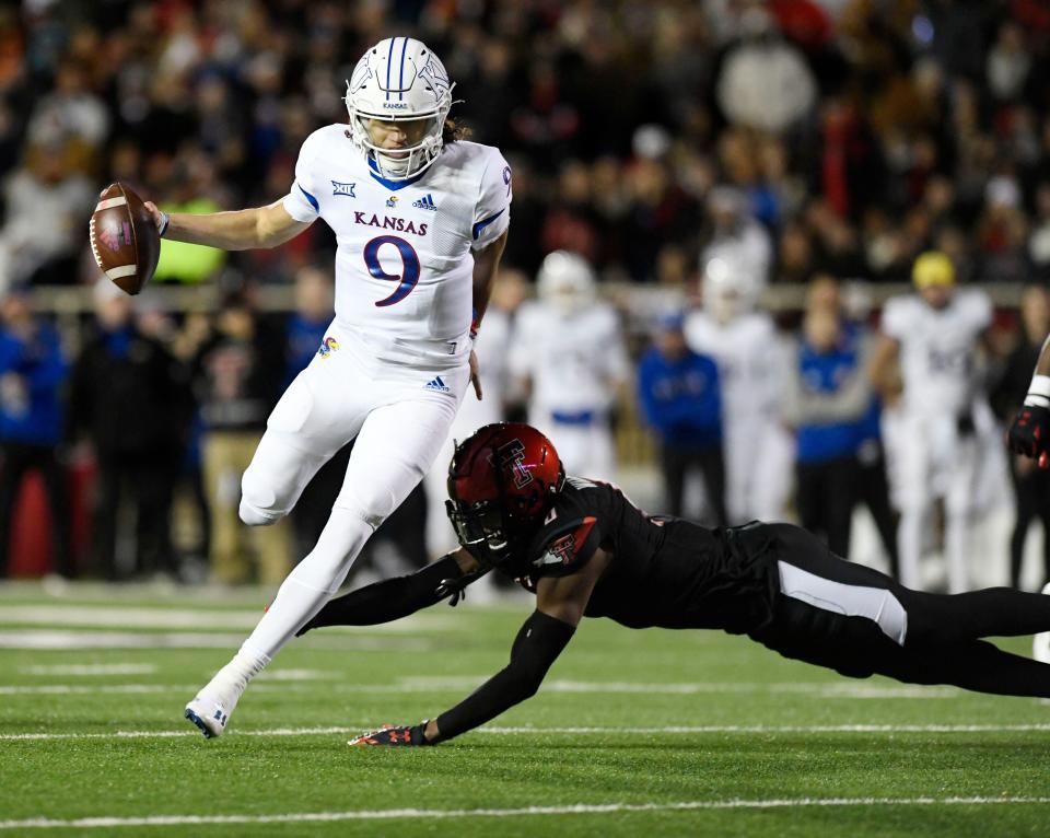 Kansas' Jason Bean runs with the ball against Texas Tech on Saturday.