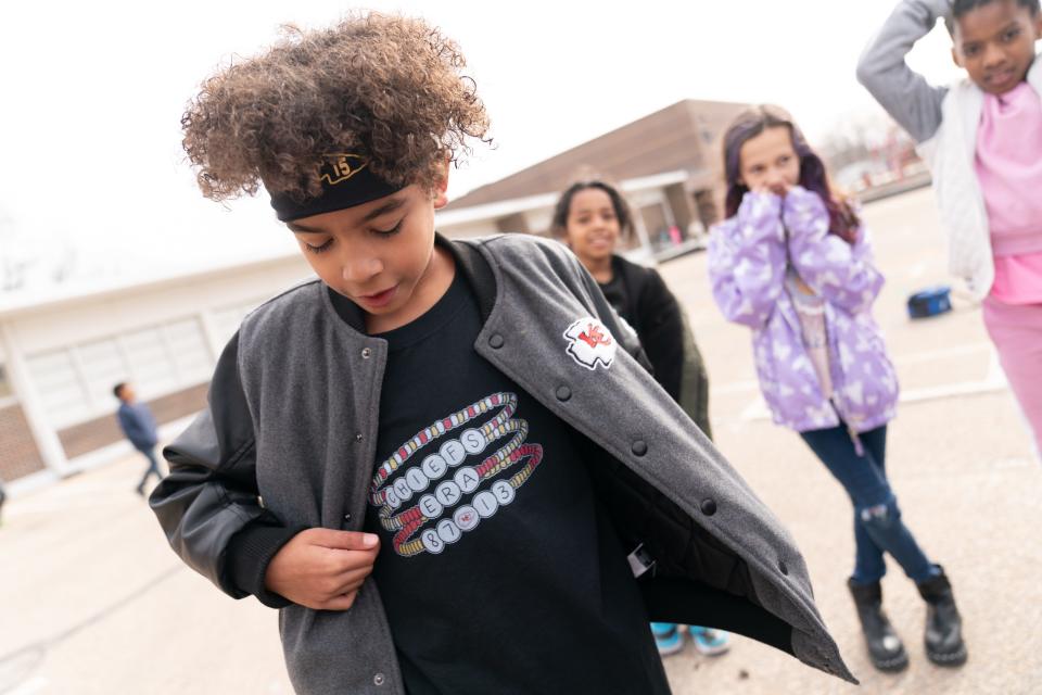 Fourth-grader Chayce White wears a T-shirt highlighting the numbers 13 and 87 while rocking a Patrick Mahomes-style headband during recess Tuesday at McClure Elementary School, which is taking part with other Topeka USD 501 schools in Chiefs Spirit Week.