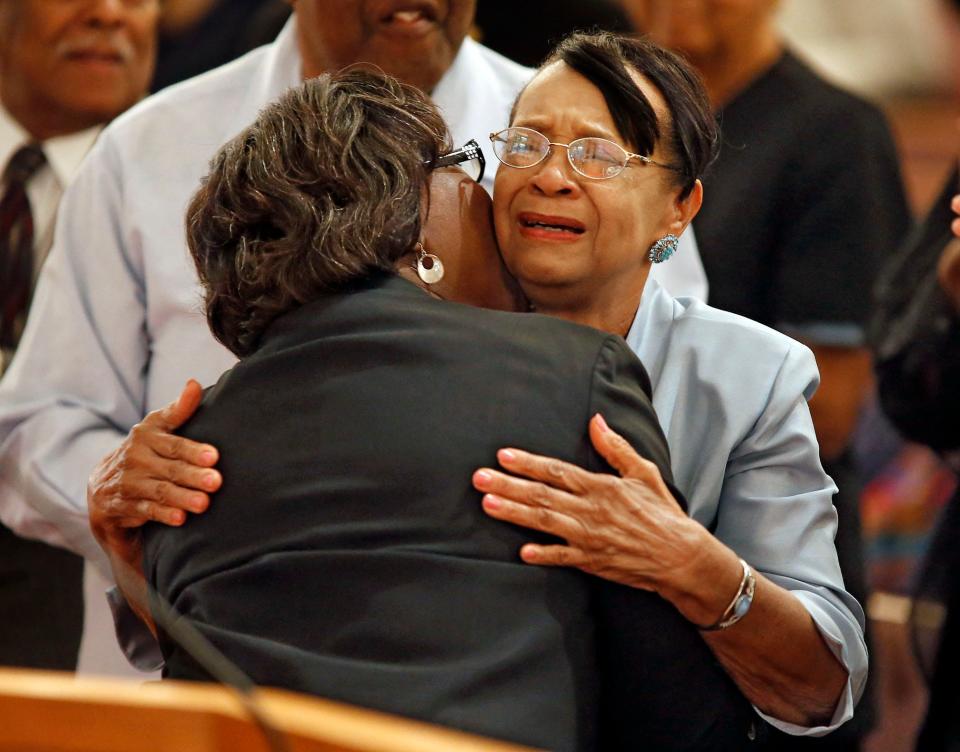 Mildred Bennett Foster, right, cries as she receives a hug from Valarie Walker Houston at a tribute to Foster held in 2014 at First Missionary Baptist Church in Winter Haven.