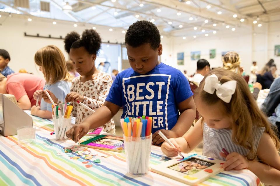 Children decorate frames to present to their moms at an event honoring extraordinary mothers hosted by Lamb Center for Arts and Healing at Guncotton Coffee in Hopewell, Va. on May 7, 2022.