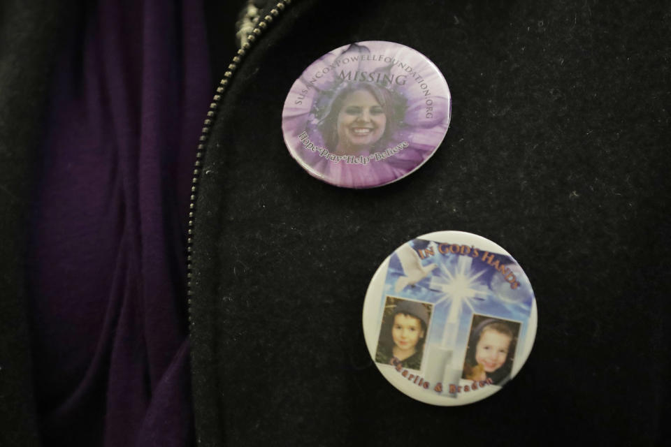 Denise Ernest, the sister of missing Utah woman Susan Cox Powell, wears buttons with the photos of her sister, Susan Cox Powell, and her nephews Charlie and Braden, Tuesday, Feb. 18, 2020, during a break in a session of Pierce County Superior Court in Tacoma, Wash., on the first day of a civil lawsuit over the murder of the Charlie and Braden, who were attacked and killed by their father Josh Powell in 2012 while he was under suspicion for Susan Powell's disappearance. The parents of Susan Cox Powell allege that negligence by the Washington state Department of Social and Health Services was a contributing factor that led to the deaths of their grandsons. (AP Photo/Ted S. Warren)