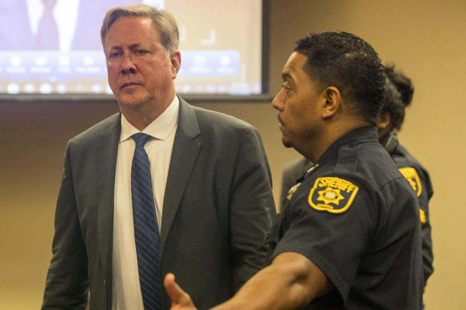 Former DeKalb County police officer Robert Olsen becomes prepares to be processed after his sentencing, Friday, Nov. 1, 2019, in Decatur, Ga. Olsen, who was convicted of aggravated assault and other crimes in the fatal shooting of an unarmed, naked man, was sentenced Friday to 12 years in prison.. (Alyssa Pointer/Atlanta Journal-Constitution via AP)