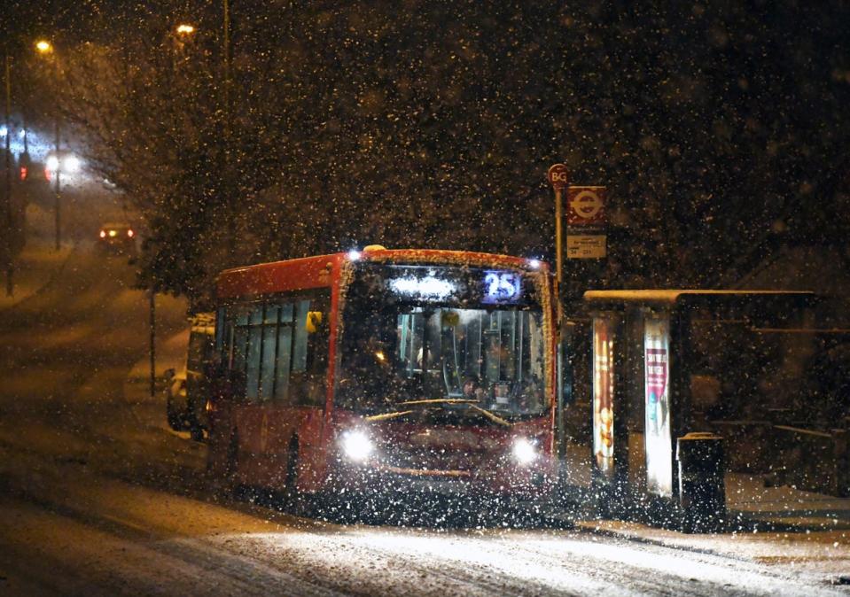 UK: A bus drives through a snow shower in London (EPA)