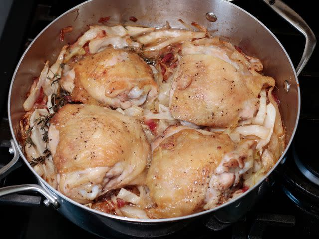 <p>Serious Eats / Jesse Raub</p> Thinner pans (like the one shown here) struggled to brown chicken thighs as well as the thicker models.