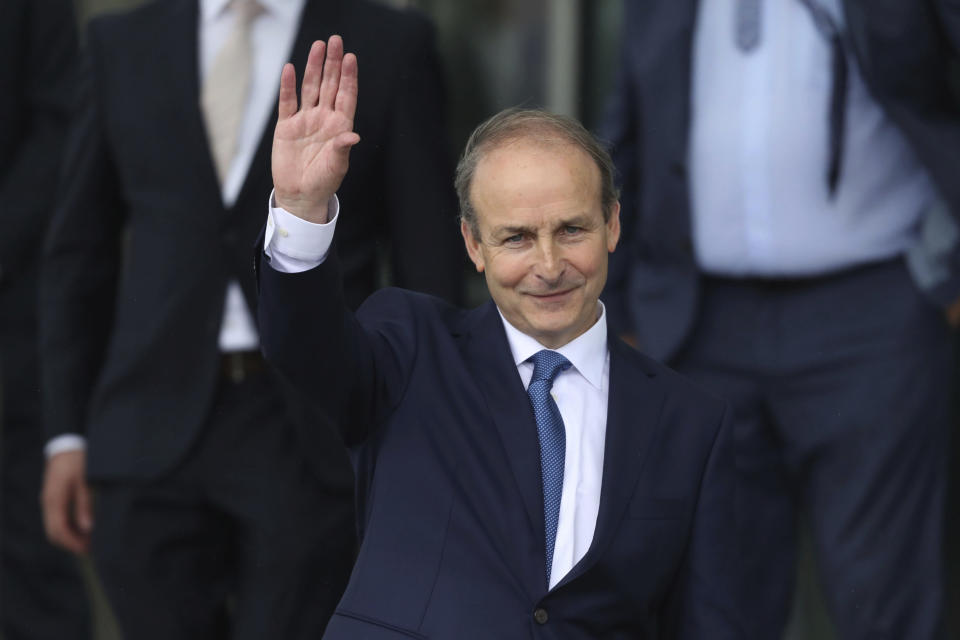 Fianna Fail party leader Micheal Martin leaves the Dail government in Dublin, where he has been officially elected as the new Irish Premier, Saturday June 27, 2020. As part of a pact between Martin and former premier Varadkar, Martin will take the role of Premier until December 2021, with Mr Varadkar resuming the role for the remainder of the Government term of office. (Niall Carson/PA via AP)