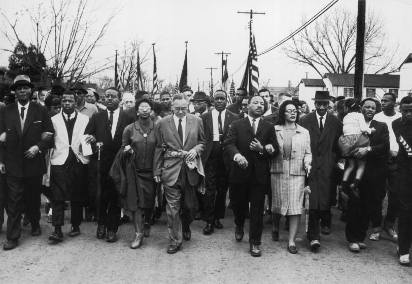 March 1965: American civil rights campaigner Martin Luther King (1929 - 1968) and his wife Coretta Scott King lead a black voting rights march from Selma, Alabama, to the state capital in Montgomery; among those pictured are, front row, politician and civil rights activist John Lewis (1940 - 2020), Reverend Ralph Abernathy (1926 - 1990), Ruth Harris Bunche (1906 - 1988), Nobel Prize-winning political scientist and diplomat Ralph Bunche (1904 - 1971), activist Hosea Williams (1926 - 2000). (Photo by William Lovelace/Express/Getty Images)