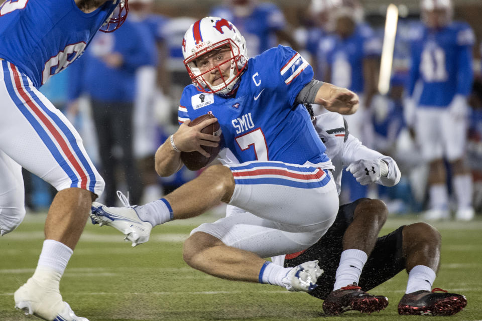 SMU quarterback Shane Buechele (7) is tackled by Cincinnati linebacker Jarrell White (8) for a loss during the first half of an NCAA college football game Saturday, Oct. 24, 2020, in Dallas. (AP Photo/Jeffrey McWhorter)