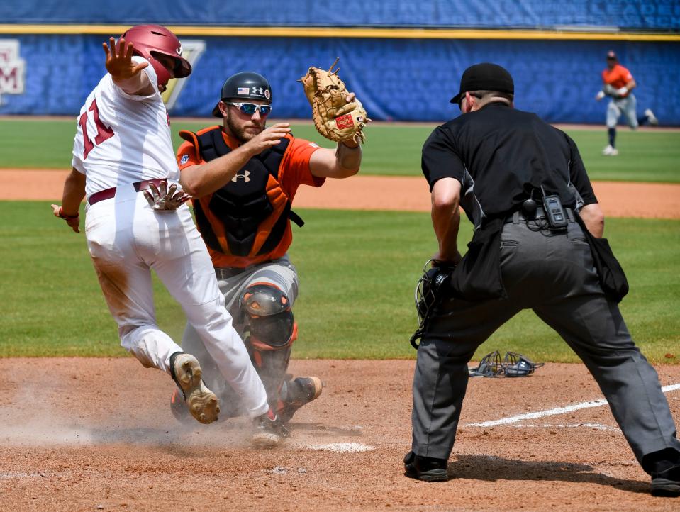 Auburn catcher Nate LaRue tags out Alabama base runner William Hamiter (11) during the SEC Tournament elimination game Thursday, May 25, 2023, at the Hoover Met. Alabama defeated Auburn 7-4 to advance.