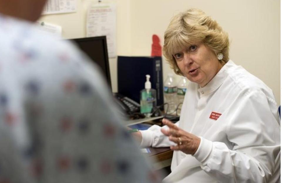 Lab technician Donna Magnanti talks with a patient at the Framingham Heart Study Clinic in September 2018.