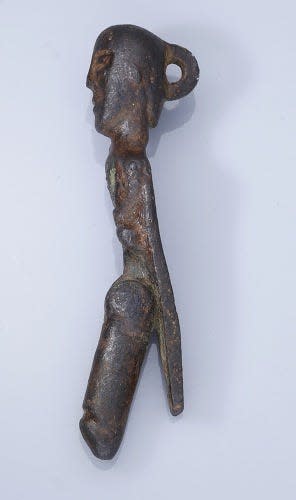 A profile shot of the bronze man where the moving phallic hinge is visible.