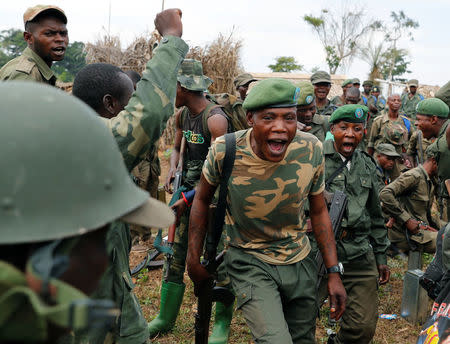 Congolese soldiers from the Armed Forces of the Democratic Republic of Congo (FARDC) shout before their mission against ADF rebels in a temporary base near the town of Kimbau, North Kivu Province, Democratic Republic of Congo, February 19, 2018. REUTERS/Goran Tomasevic/Files