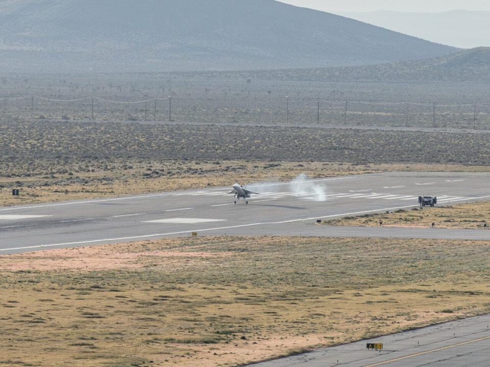 The high angle of attack landing with mountains in back ground. The XB-1 is in the distance some.