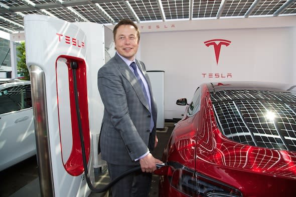 LONDON, ENGLAND - Saturday, June 7, 2014: CEO &amp; Chief Product Architect Elon Musk plugs in a Supercharger to a right-hand drive Model S at the UK launch of Tesla Motors&#39; Model S electric car at the Crystal. (Pic by David Rawcliffe/Propaganda)