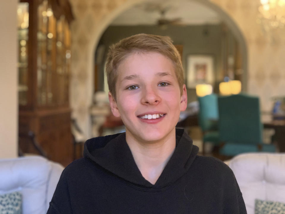 This Monday, May 4, 2020 photo provided by his family shows Hudson Drutchas, 12, in his Chicago home. Drutchas is a sixth-grader and is, because he lives in a state that still has a stay-at-home order, is doing his schoolwork online. He says he feels like he's missing part of his childhood because of the global pandemic. (Kristin Drutchas via AP)