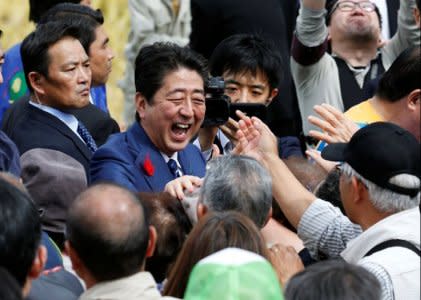 Japan's Prime Minister Shinzo Abe, who is also ruling Liberal Democratic Party leader, shakes hands with his supporters after an election campaign rally in Fukushima, Japan, October 10, 2017.    REUTERS/Toru Hanai