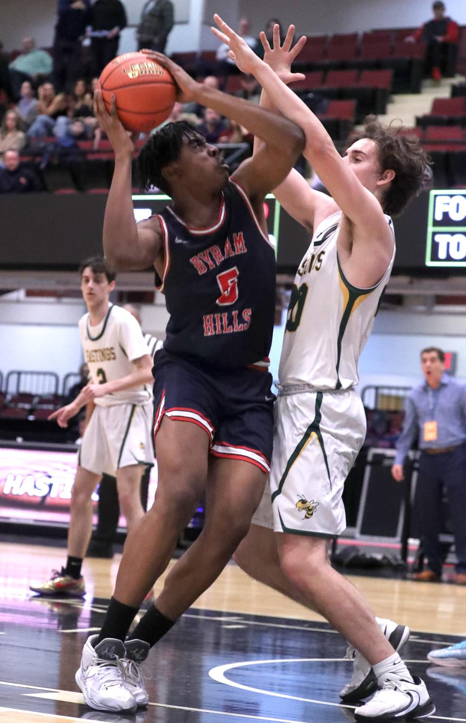 Byram Hills' Zac Efobi shoots over Hastings' Keith Capuanoduring a Class B semifinal at the Westchester County Center Feb. 27, 2023. Byram Hills won 54-32.