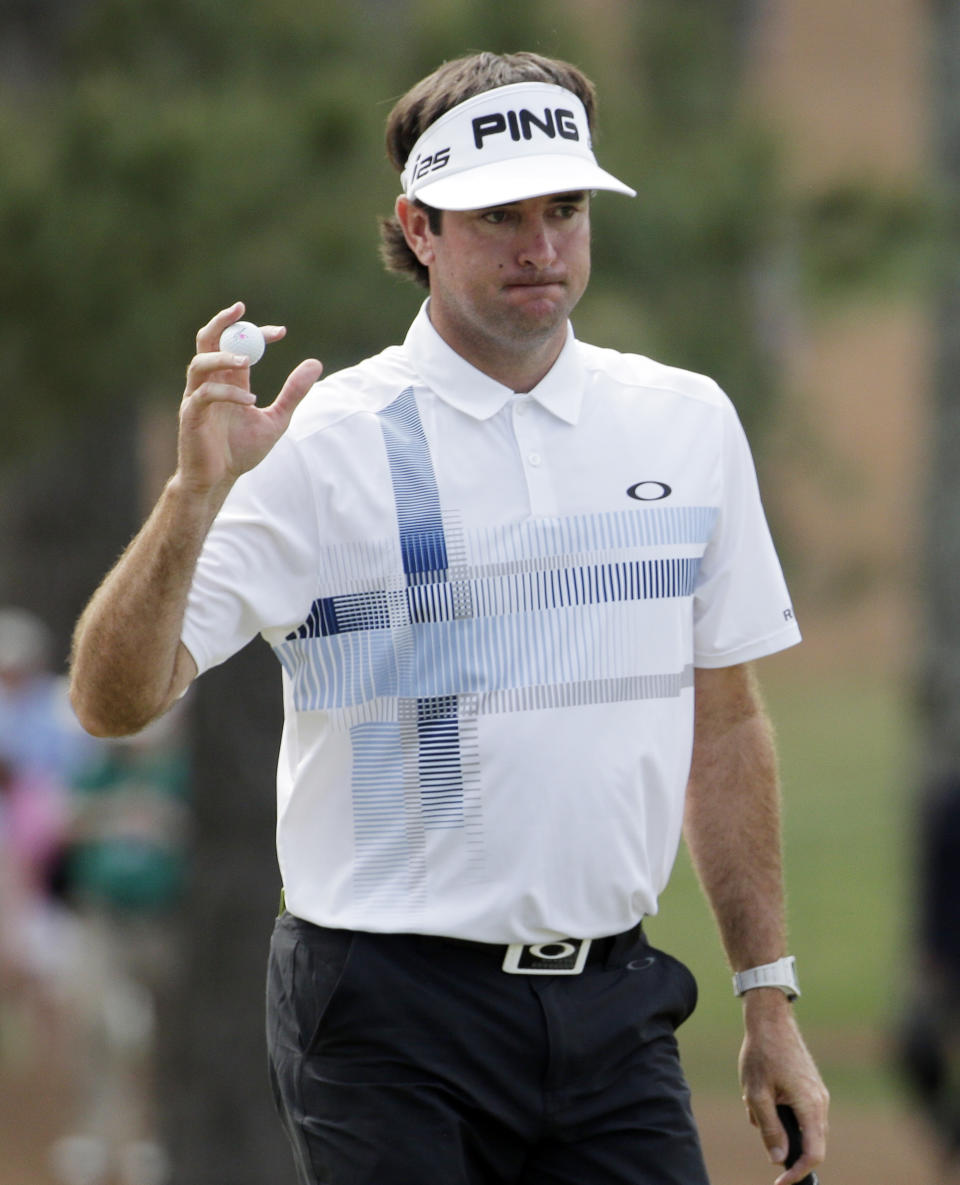 Bubba Watson holds up his ball after a par putt on the seventh green during the fourth round of the Masters golf tournament Sunday, April 13, 2014, in Augusta, Ga. (AP Photo/Chris Carlson)