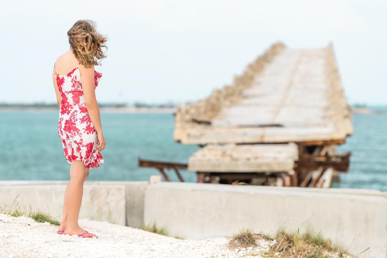 young woman standing in front of Old Seven Mile Bridge, Florida Keys