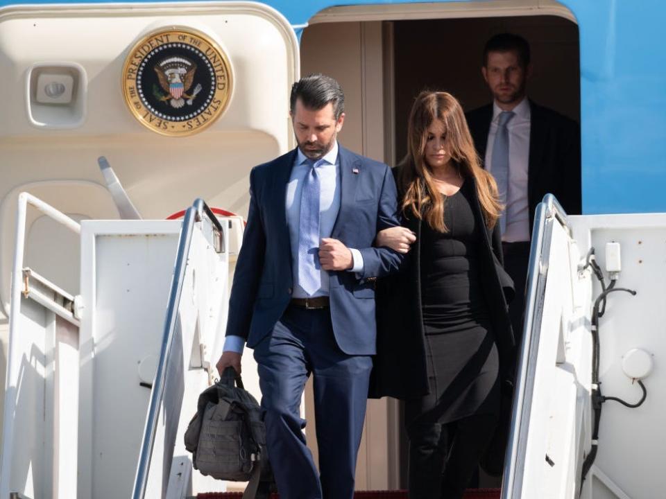 Donald Trump Jr. and Kimberly Guilfoyle exit Air Force One at the Palm Beach International Airport in January 2021.